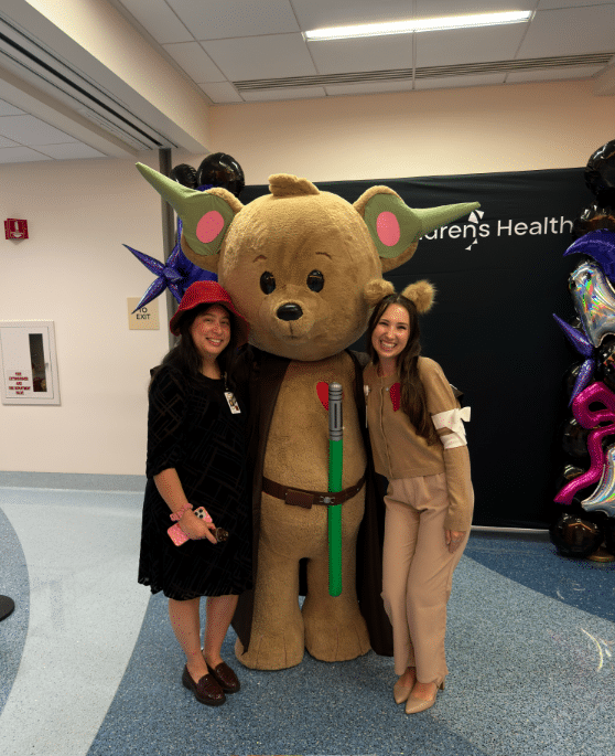 Briana Powell and another woman with a costumed bear mascot